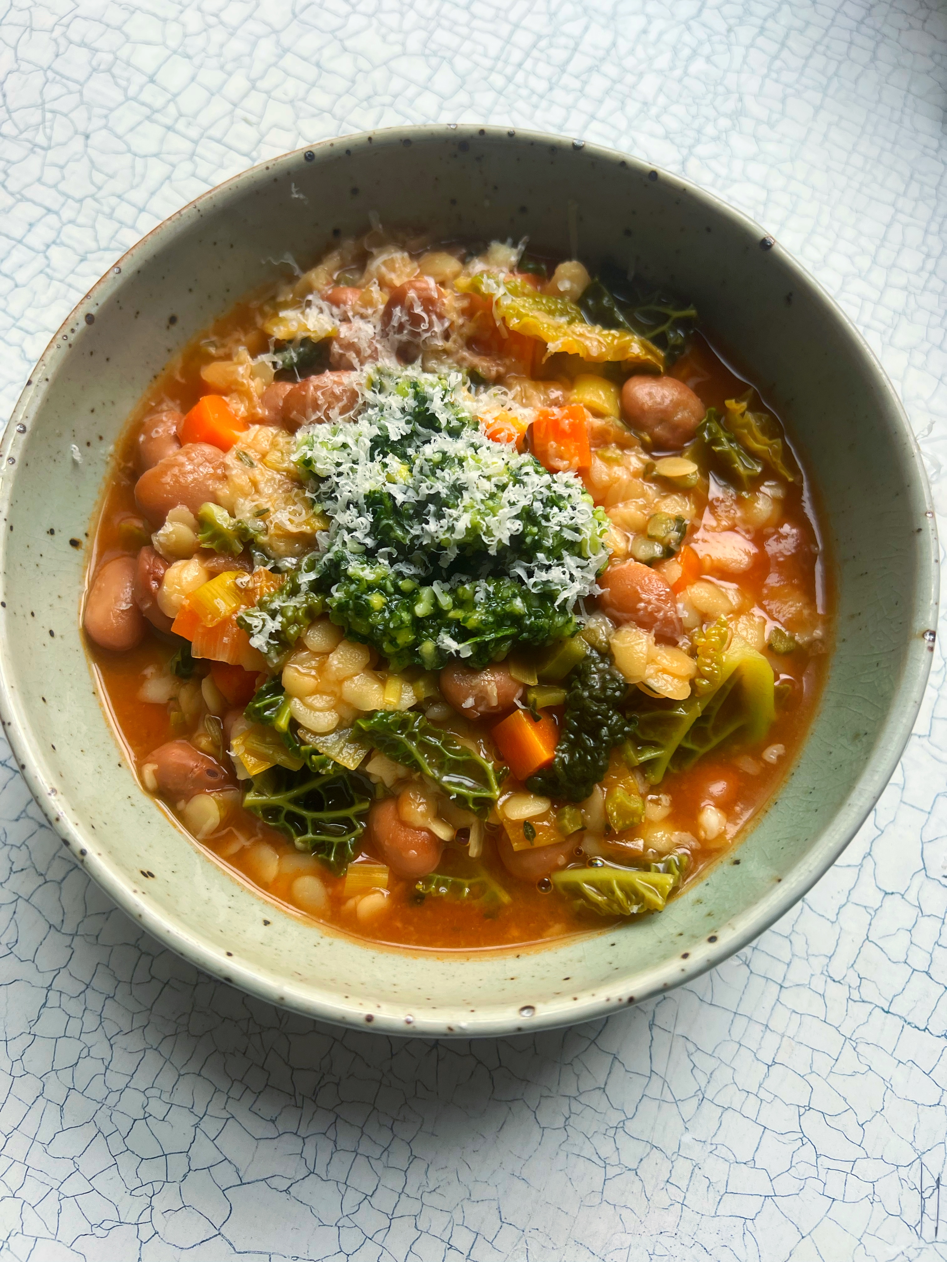 Cabbage and bean pasta soup with kale pesto